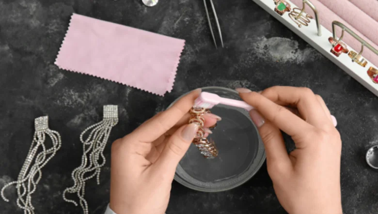 Cleaning jewelry in water with brush